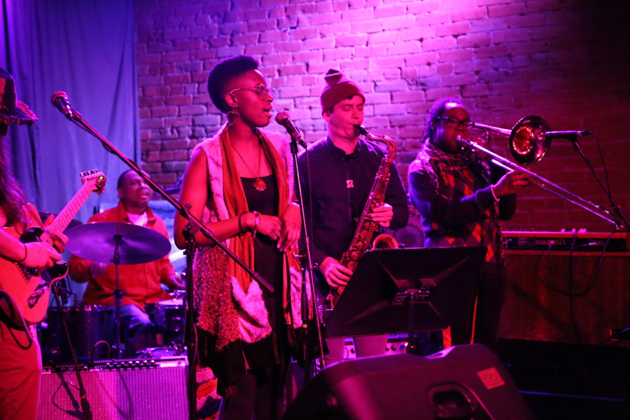 B Love performing live with vocalist and horn section