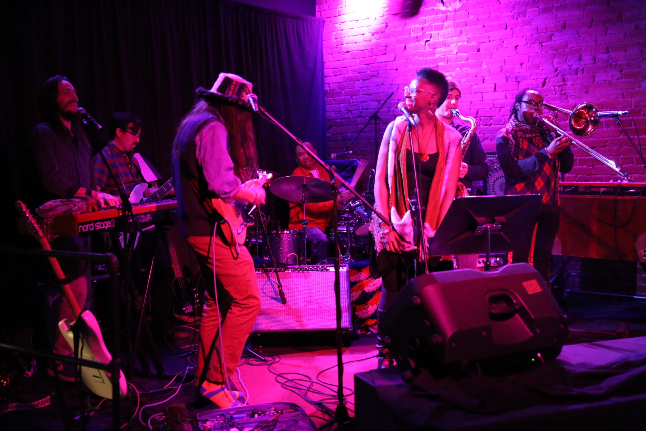 B Love vocalist and horn section sharing the stage